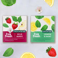 Two tea bags of LiveFresh – On the left, “Wild Berry Fruit Tea” with strawberries and apple; on the right, “Lemon & Mint Green Tea” with lemon slices and mint leaves; garnished with complementary fruits and leaves.