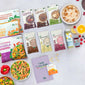 Verschiedene Produkte einer 7-Tage-Food-Kur von LiveFresh, darunter Fertiggerichte, Trinkmahlzeiten, Porridge, Säfte und Vitamine. Daneben liegen Zitronen, Himbeeren, Blaubeeren und Paprika. 