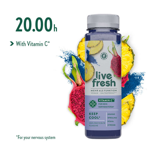 LiveFresh “Keep Cool” juice with pineapple, spirulina, pitaya, and lemon, against a background of sliced pineapple, pink dragon fruit, and spirulina powder. The recommended time to drink the juice during the juice cleanse is 8 p.m.  There is also a note stating “with vitamin C” to support the nervous system.